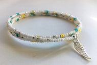 Beaded memory wire bracelet - white, turquoise, yellow and silver beads with angel wing pendant - eDgE dEsiGn London