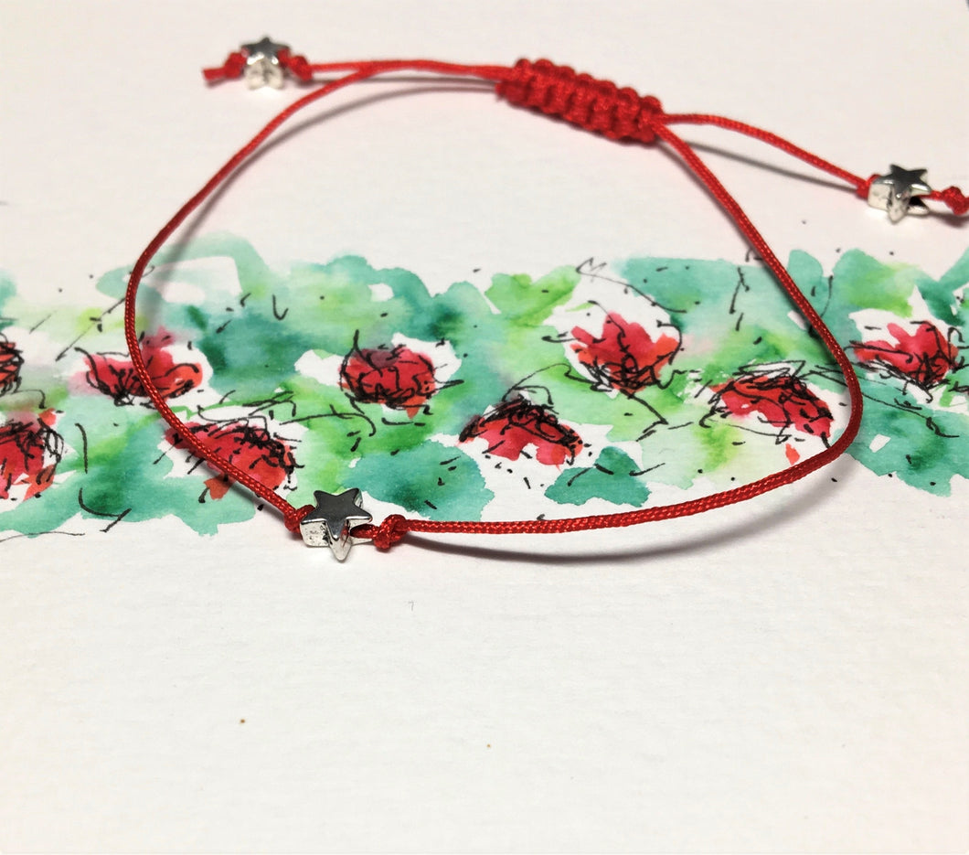Single strand red cord bracelet with silver stars - adjustable sliding knot fastening - eDgE dEsiGn London